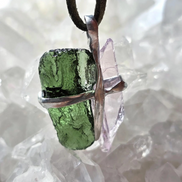 Pendant with 3.49g apple green moldavite from Ločenice and pale pink kunzite held by crossing metal bands.