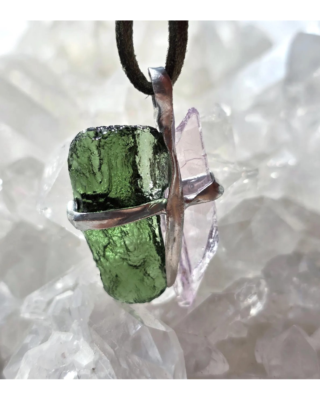 Pendant with 3.49g apple green moldavite from Ločenice and pale pink kunzite held by crossing metal bands.