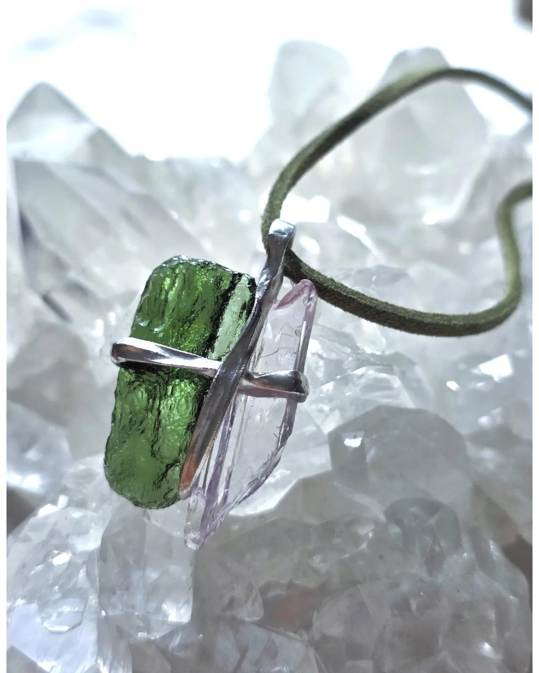 Pendant with 3.49g apple green moldavite from Ločenice and pale pink kunzite held by crossing metal bands.