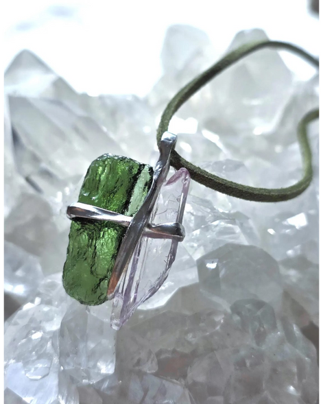 Pendant with 3.49g apple green moldavite from Ločenice and pale pink kunzite held by crossing metal bands.