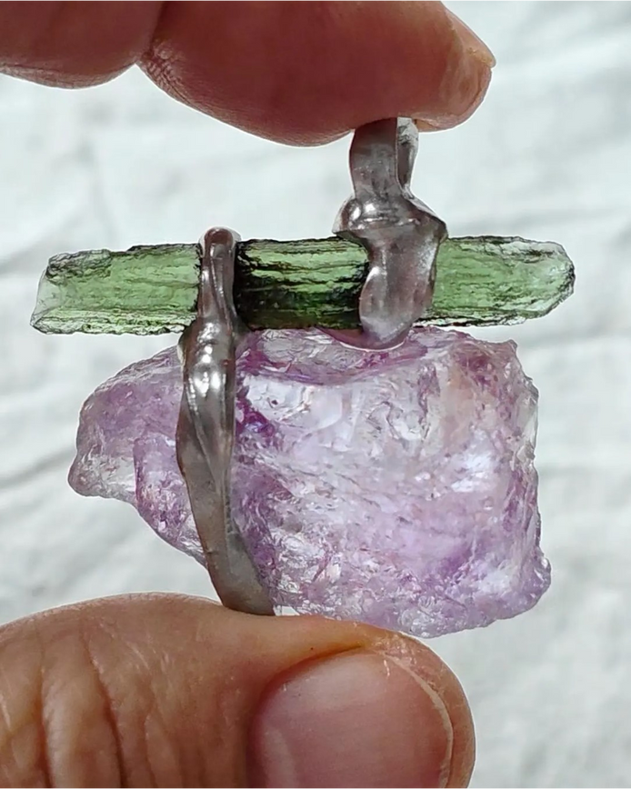 Handcrafted pendant with a 1.08g transparent green Moldavite from Chlum and Amethyst in a lead-free tin alloy setting with copper wire.