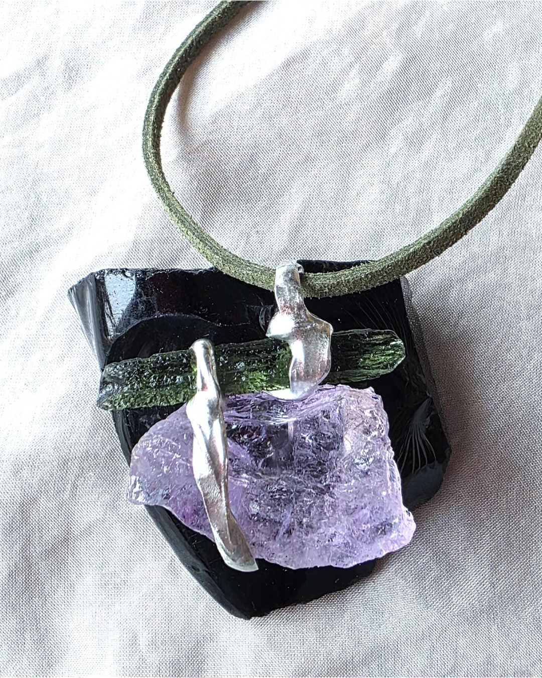 Handcrafted pendant with a 1.08g transparent green Moldavite from Chlum and Amethyst in a lead-free tin alloy setting with copper wire.