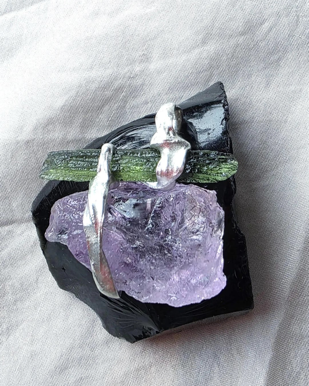 Handcrafted pendant with a 1.08g transparent green Moldavite from Chlum and Amethyst in a lead-free tin alloy setting with copper wire.