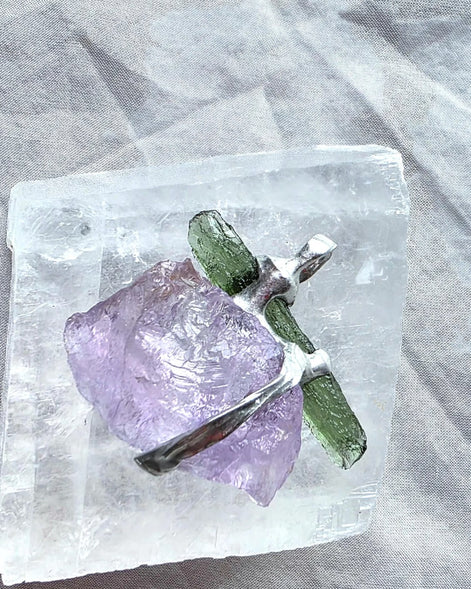 Handcrafted pendant with a 1.08g transparent green Moldavite from Chlum and Amethyst in a lead-free tin alloy setting with copper wire.