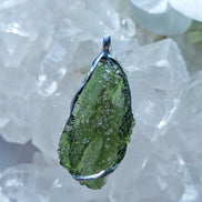 Transparent green Chlum Moldavite pendant in an open handcrafted setting