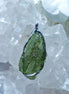 Transparent green Chlum Moldavite pendant in an open handcrafted setting