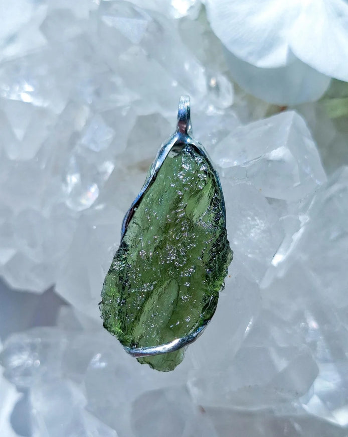 Transparent green Chlum Moldavite pendant in an open handcrafted setting
