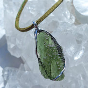 Transparent green Chlum Moldavite pendant in an open handcrafted setting