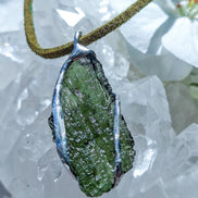 Transparent green Chlum Moldavite pendant in an open handcrafted setting back-side