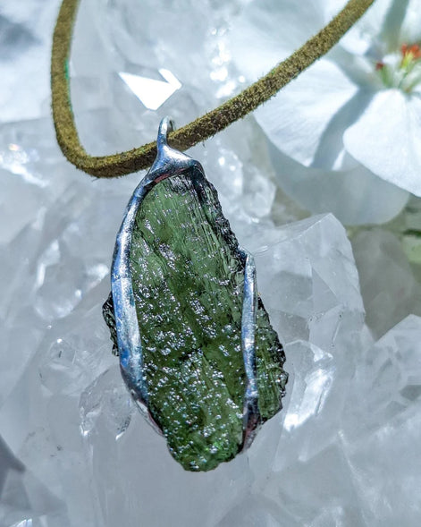 Transparent green Chlum Moldavite pendant in an open handcrafted setting back-side
