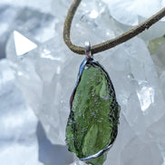 Transparent green Chlum Moldavite pendant in an open handcrafted setting